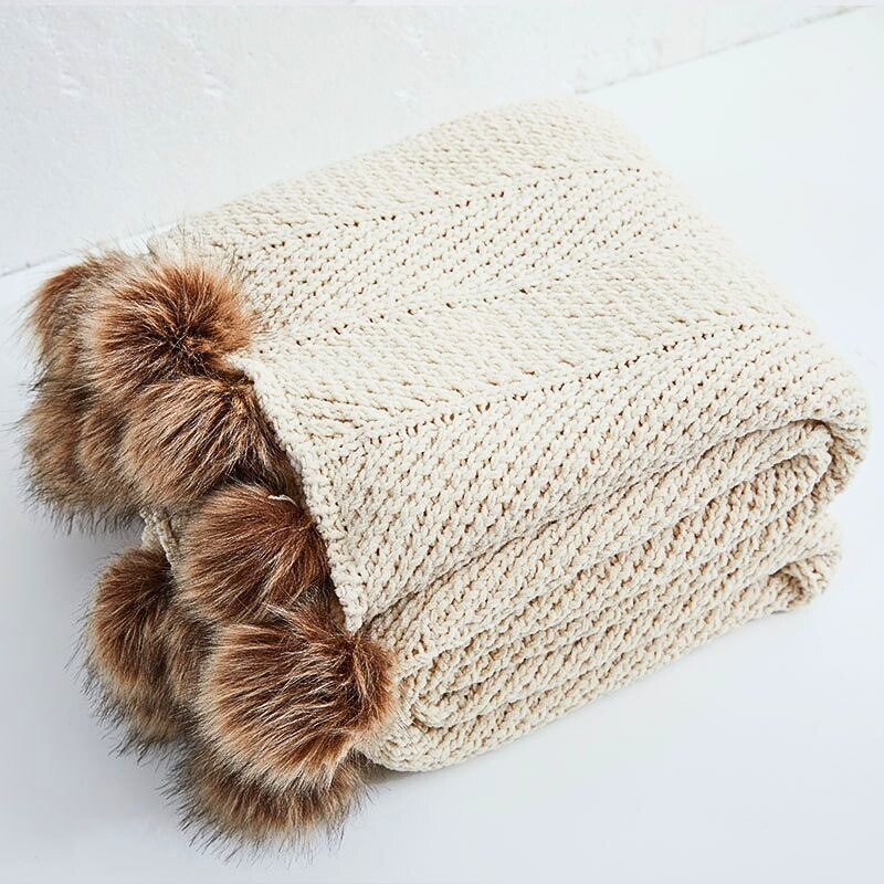 High-end chenille knit throw styled with decorative faux fur poms – Pottery Barn dupe
