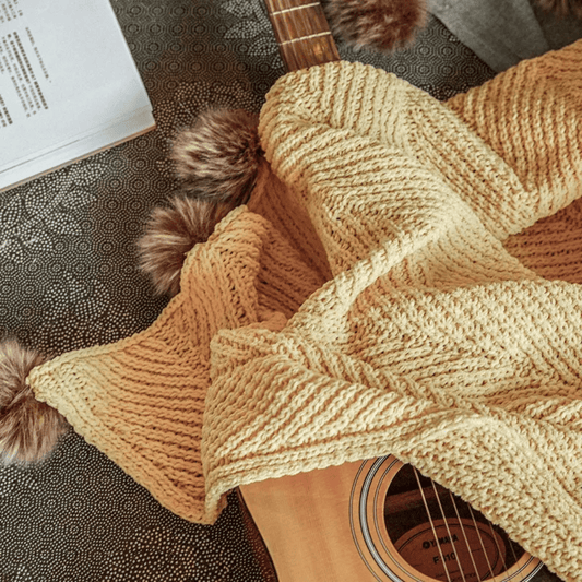 Luxury chenille knit throw blanket with faux fur poms draped over a sofa – ultra soft and cozy, Pottery Barn inspired
