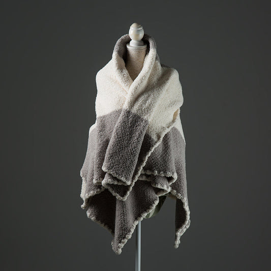 A luxurious chenille throw blanket in white and gray gradient pattern, styled and wrapped on a dressmakers stand as a shawl. 